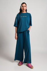 Opal – LaRosa Night Wears for Women – Cotton Summer Sets Collection | Larosawears | Shop Online – Front View.
Woman wearing a teal outfit with wide-leg pants and a matching top on a plain background